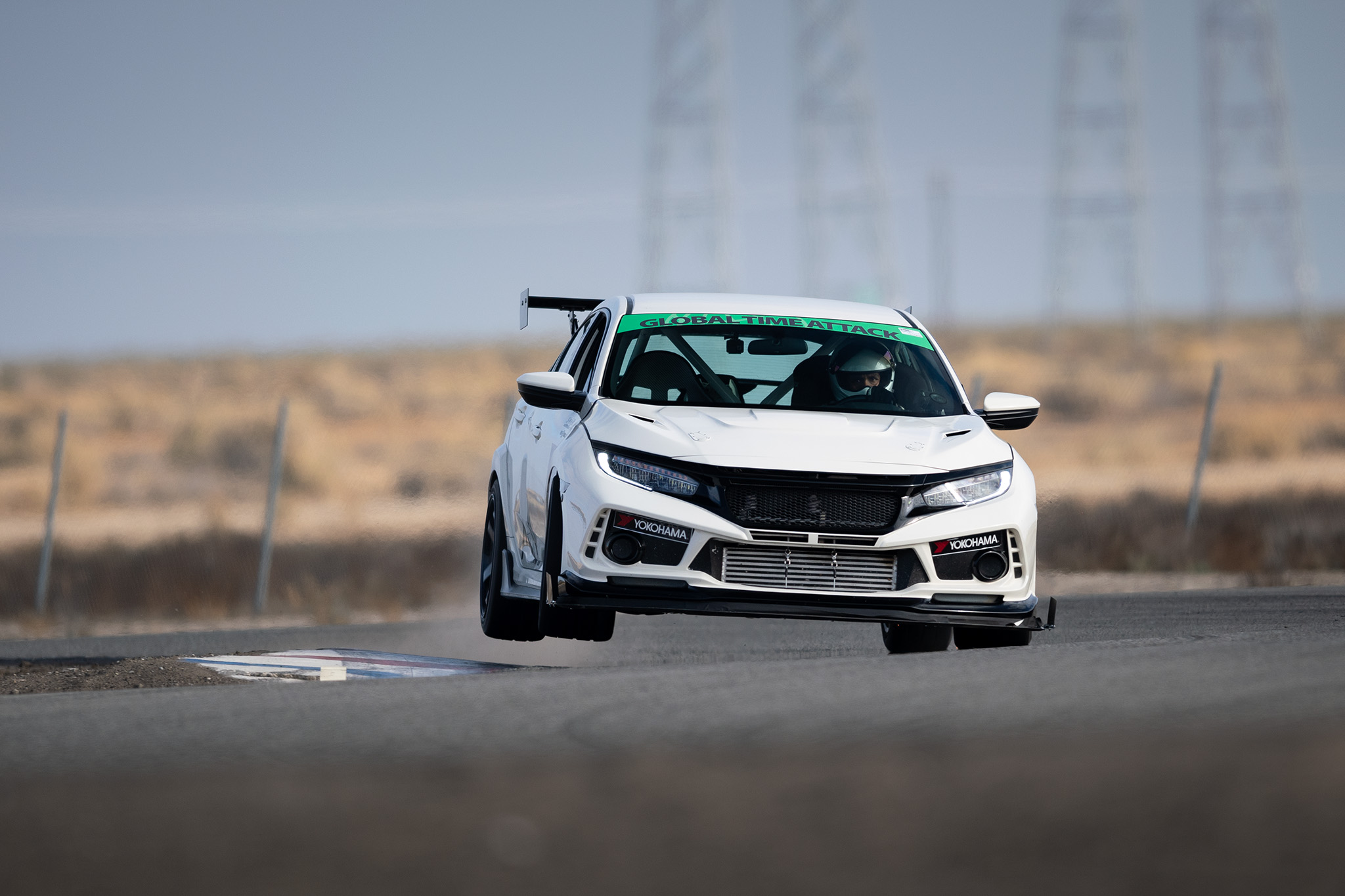 Jose Mejia bouncing his FK8 Honda Civic Type R off the Buttonwillow curbing at Global Time Attack finals, motorsports photography by Luke Munnell
